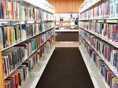 The view between the book stacks, with shelves full of books lining either side of the image.