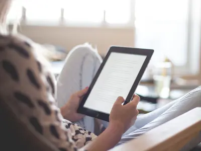 A person holding an e-reader.