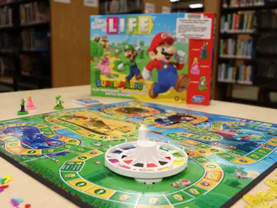 Mario-themed Game of Life board game on a library table.