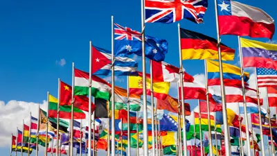 Dozens of flags from nations around the world blowing in the wind.