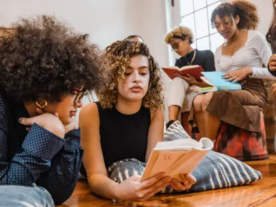 A group of young women silently reading.