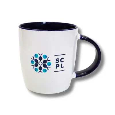 A white mug with a navy blue handle and interior. The mug has the library logo on the front.