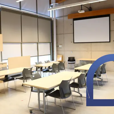 A meeting room with tables and chairs.