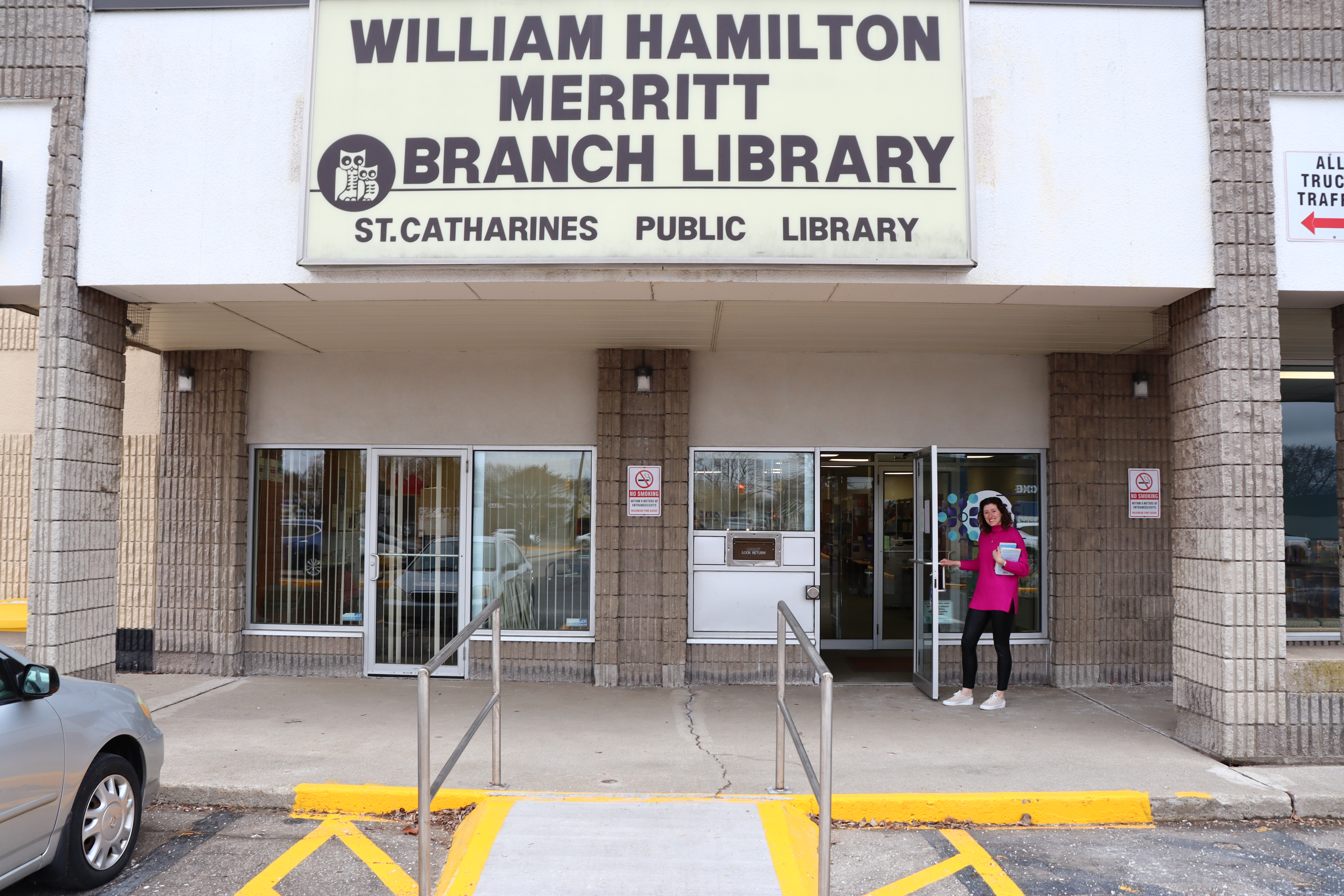 An SCPL staff member holds the door open at the Merritt Branch.