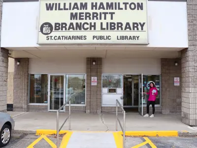 An SCPL staff member holds the door open at the Merritt Branch.