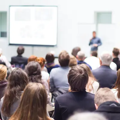 An audience of people in a lecture.