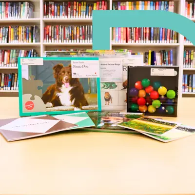 Books, puzzles, photographs, and activities on display to feature the library's memory care kits.