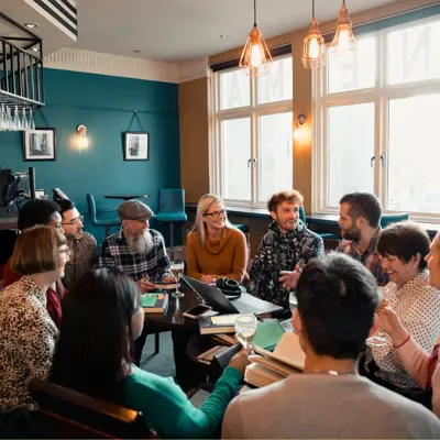 A group of people sitting in a circle having a discussion.