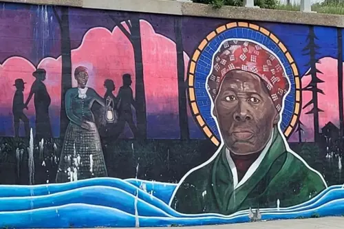 A mural of Harriet Tubman painted on a building.