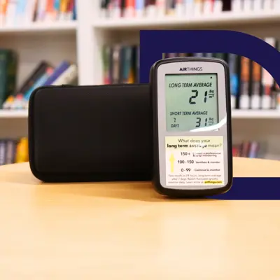 A radon gas detector displayed on a table at the library.